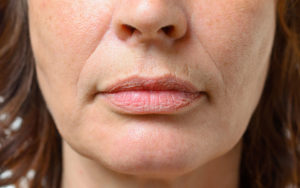 Closeup on the mouth of a middle-aged woman